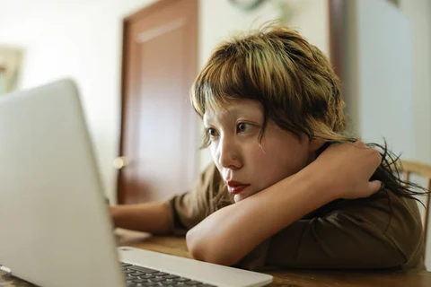 a person looking at a computer