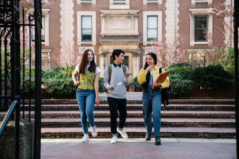 Three students walking together on campus