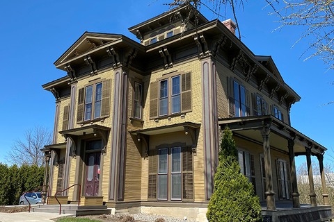 A photo of a mustard yellow Italiante style building with brown trim. This is Kitchel House, the home of the Career Center.