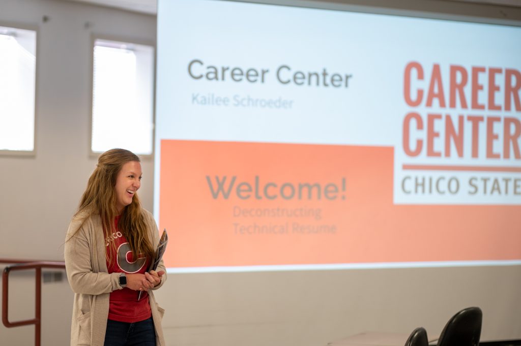 A career advisor smiling while hosting a presentation.