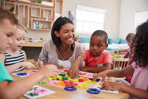 Teacher working with young children.