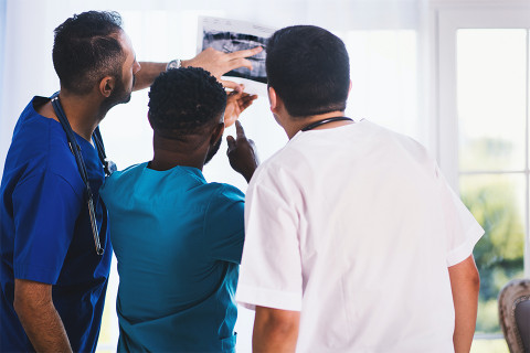 Medical team reviewing a patient's x-ray.