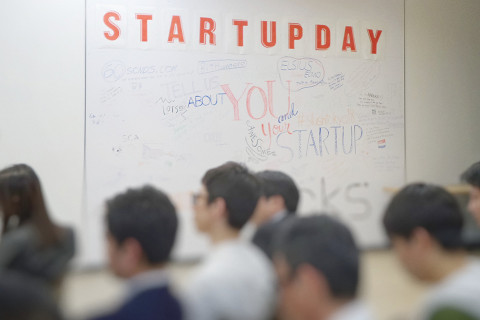 Individuals attending a presentation during a