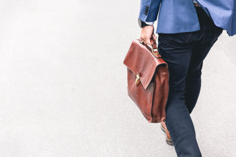 Walking with a messenger bag.