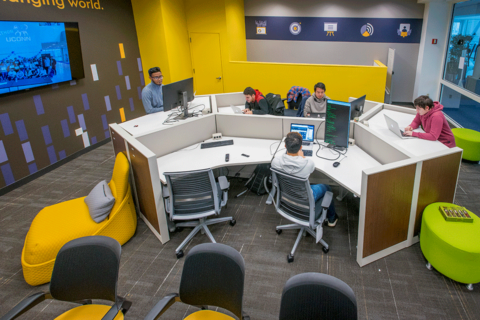 Students working in the Synchrony internship space on the UConn Stamford campus.