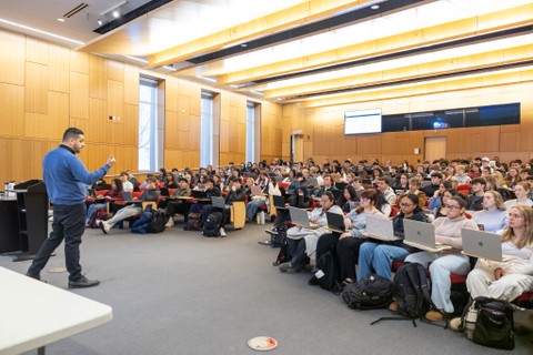 Professor speaking to students in a lecture hall