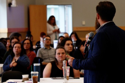 Picture of Eran Peterson giving opening remarks at Work plus supervisor summit
