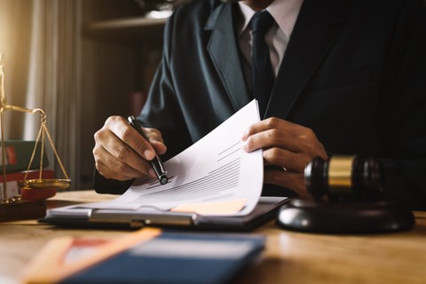 Adobe stock image of justice/law representative in suit at desk