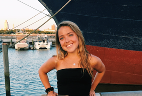 Tara McCaffrey standing in front of a boat