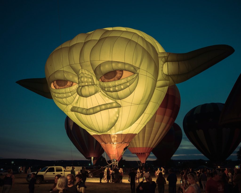 A hot air balloon in the shape of Yoda's head.