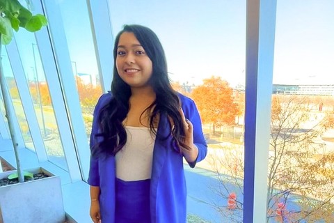 UNL student, Meylin Espinoza standing in front of a window.